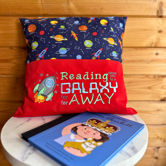 Children's reading pillow with red embroidered pocket showing a rocket and text 
